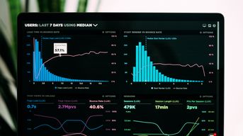 Photo Credit: https://unsplash.com/photos/JKUTrJ4vK00 / A screen with charts and graphs 